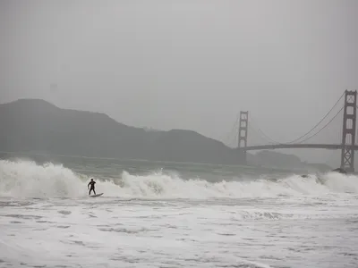 A surfer rides large waves at Baker Beach in San Francisco during one of the largest storms to hit Northern California in the last five years.