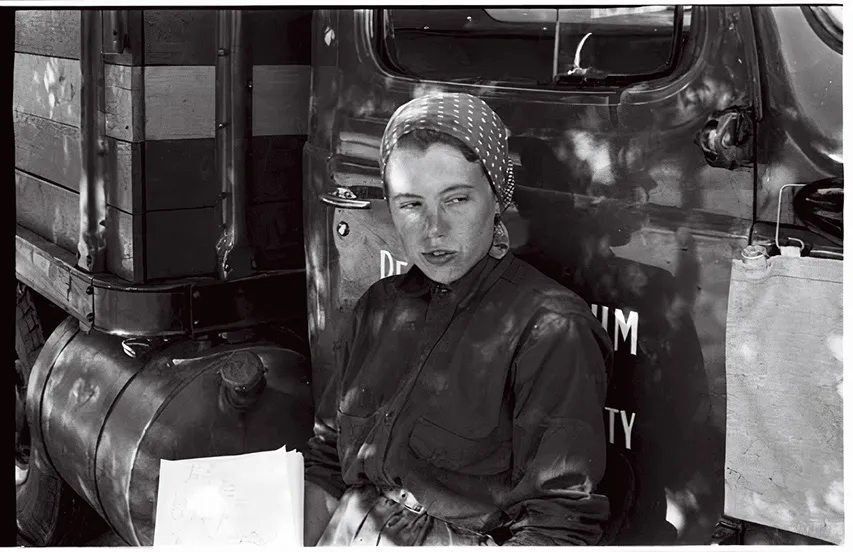 a women sits against a truck
